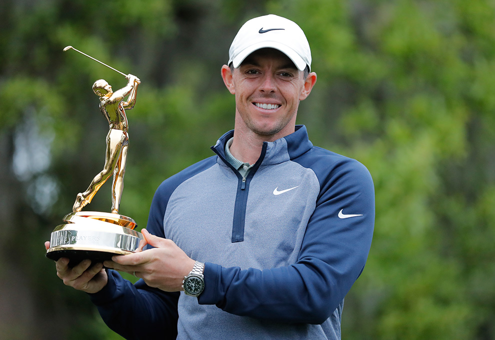 Rory holding a trophy after a win