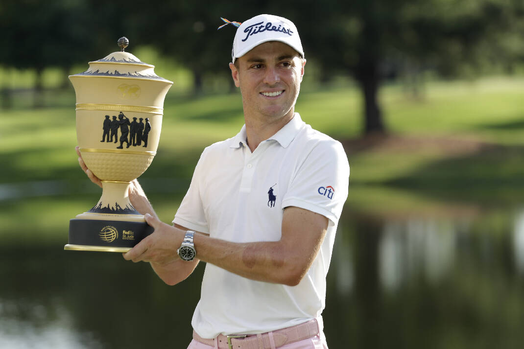 Justin Thomas holding the Player's Championship trophy.