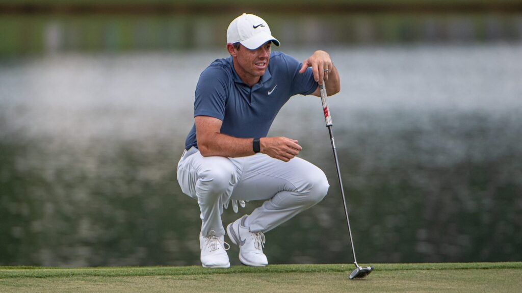 Rory Mcilroy reading the break of a left to right sliding putt.