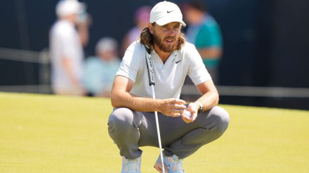 Tommy Fleetwood lining up a putt.